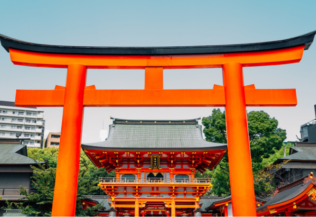 Bright red torii gate at Ikuta Shrine, a historic Shinto shrine in Kobe, Japan.