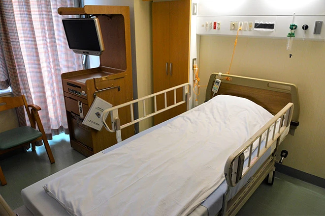 a japanese hospital room with a bed and tv