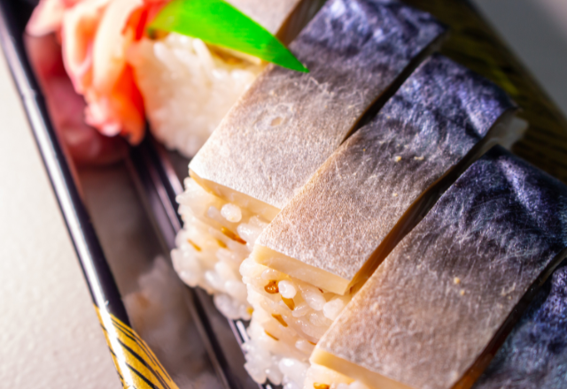 Slices of goma saba, marinated mackerel sashimi, served with sushi rice.