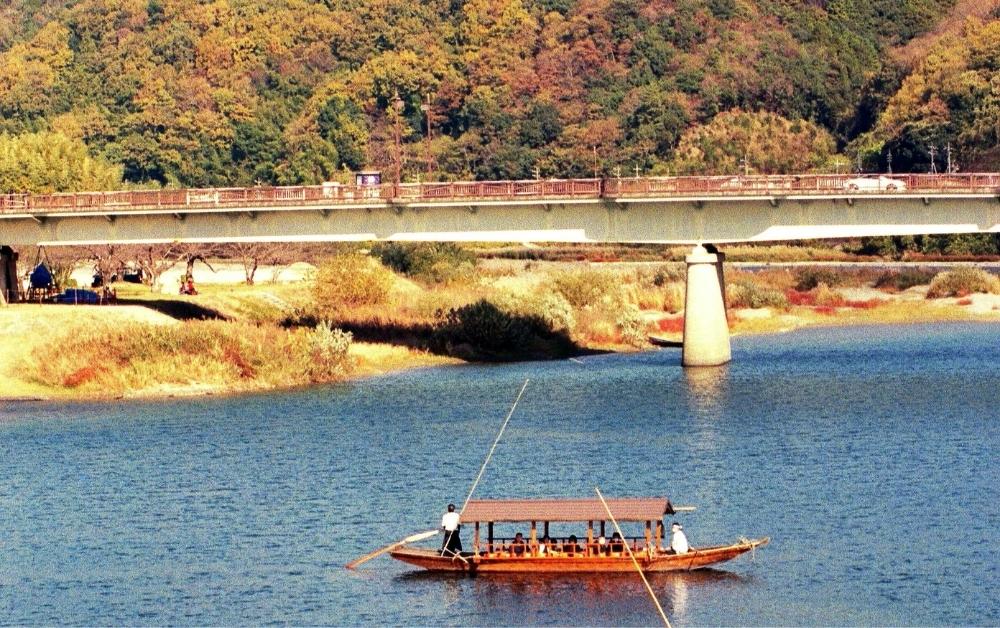 A riverboat in Kyoto during autumn.