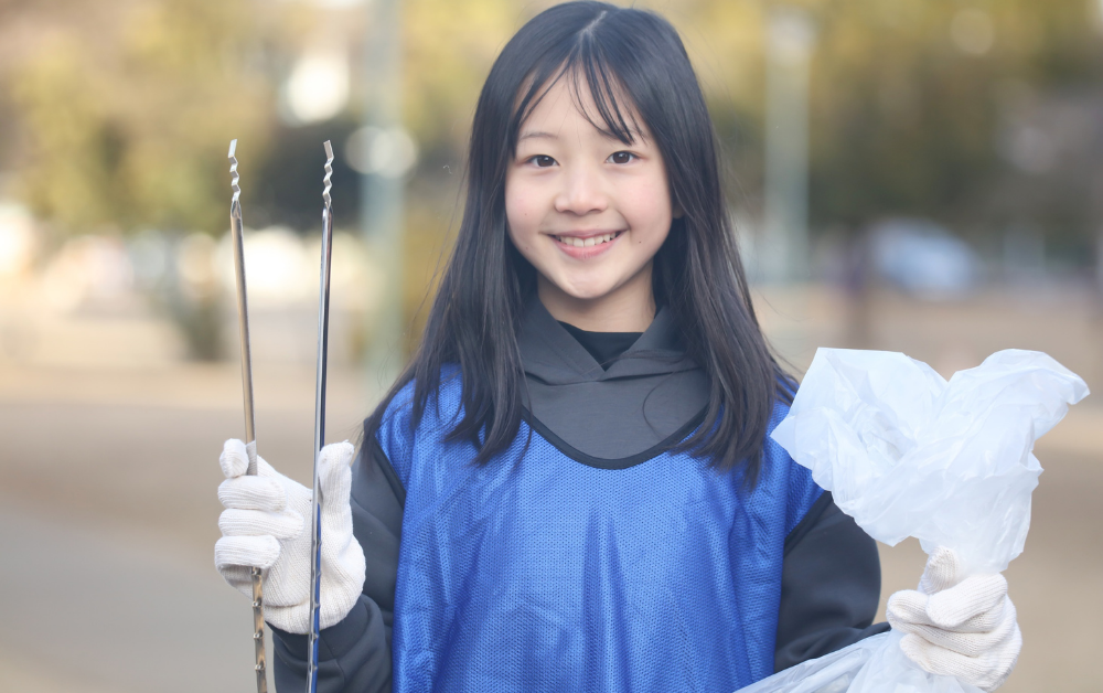 Young Japanese girl holding trash, no trash can in Japan