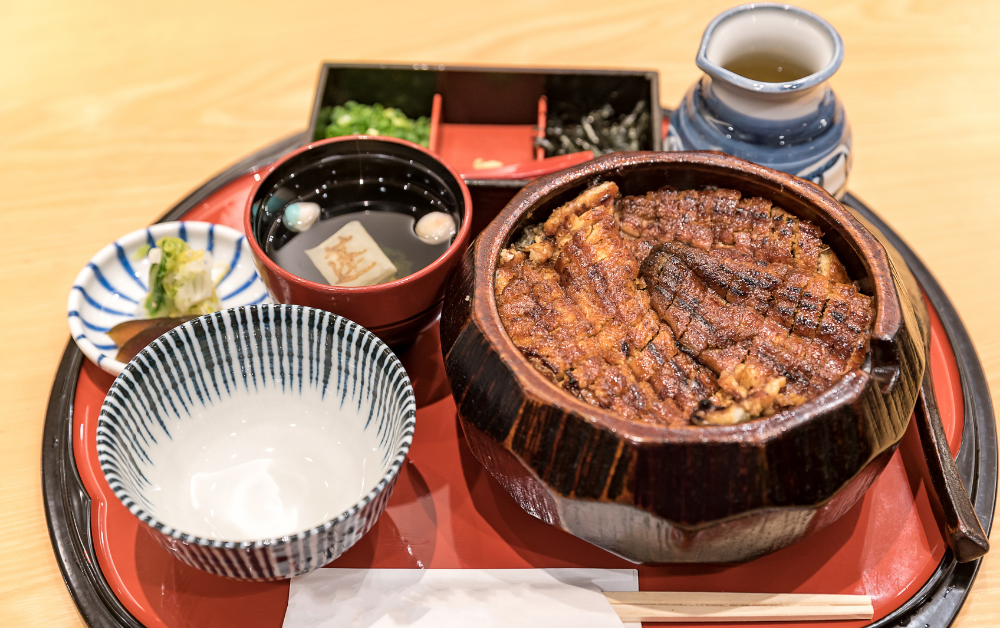 Unadon (うな丼) – grilled eel glazed with sweet soy sauce, served over rice for energy during the hottest days.